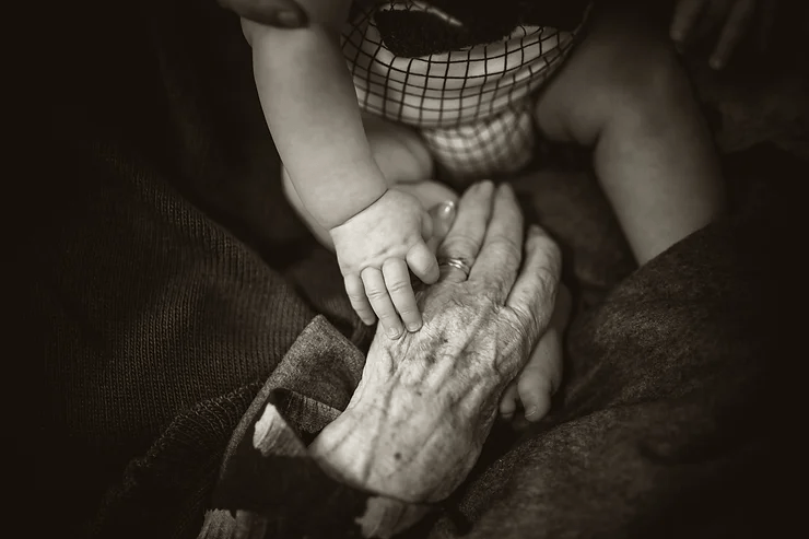 An older person and a baby