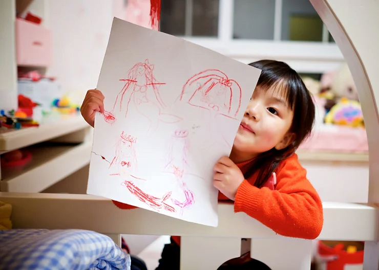 A child holding a drawing