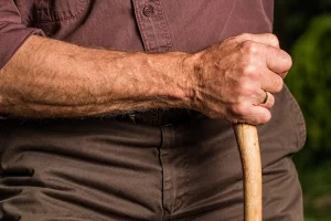 An old person with a walking stick