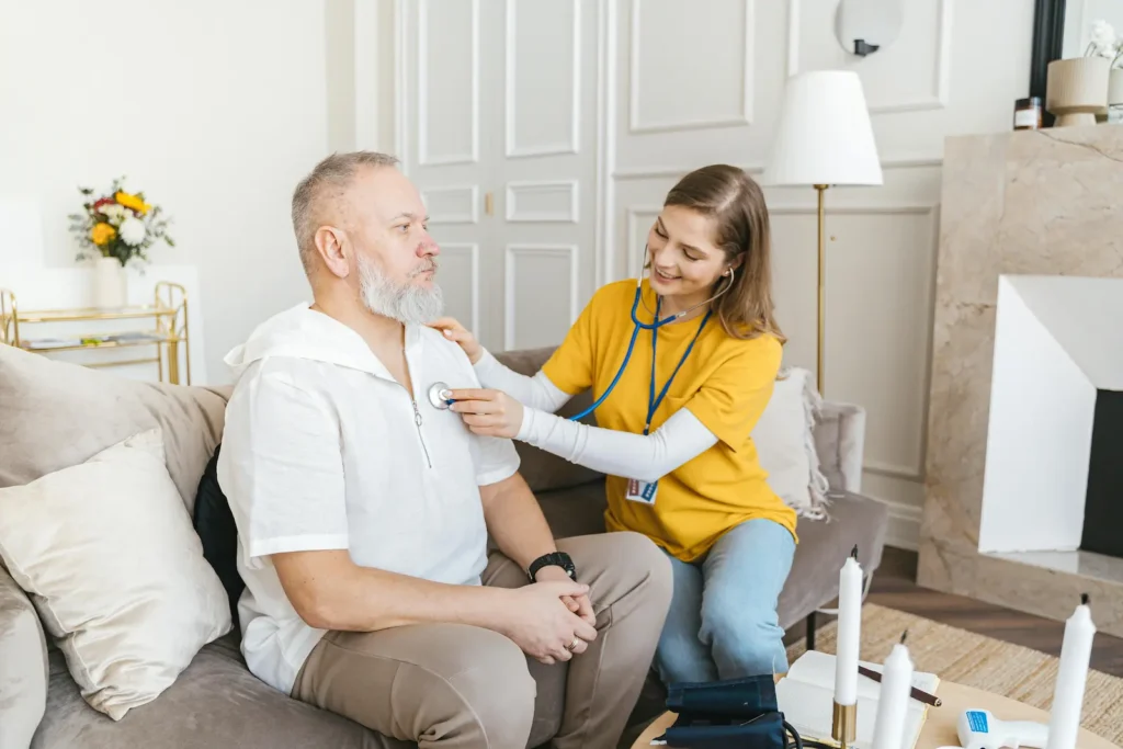 Man on sofa being cared for