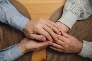 hands holding on table in a home care agency