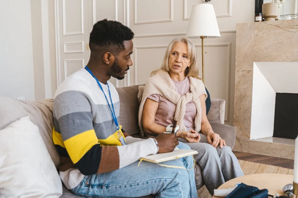 carer with elderly woman in care home
