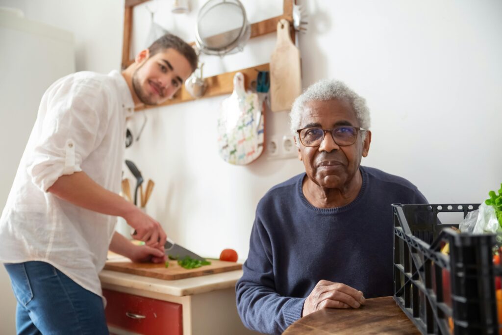 carer and old man making food