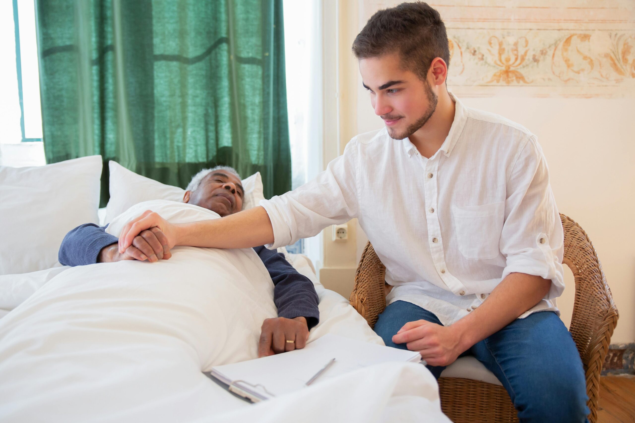 Young man caring for elderly man