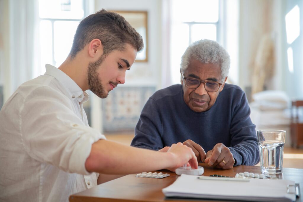 man helping elderly man